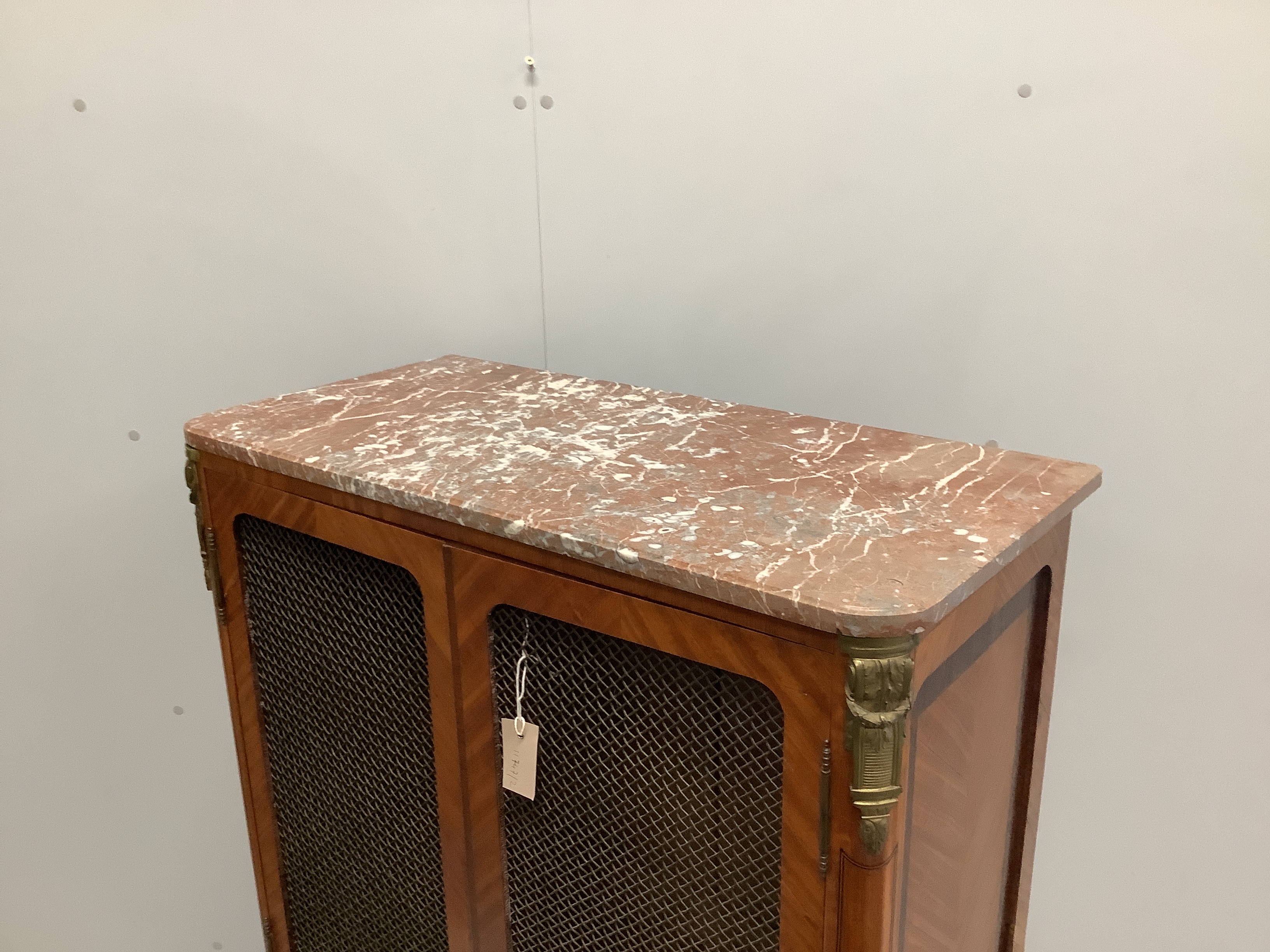 A French transitional style marble topped kingwood side cabinet, width 83cm, depth 40cm, height 145cm